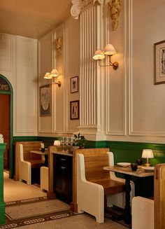 the interior of a restaurant with green and white walls