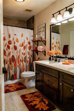 a bathroom with a shower curtain and rugs on the floor