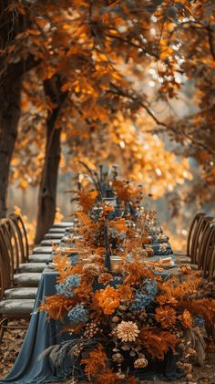 an outdoor table set up with blue and orange flowers