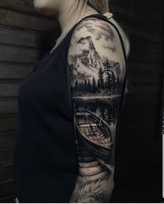 a woman with a mountain scene tattoo on her arm