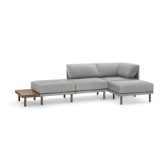 a gray couch with wooden legs and a coffee table in front of it on a white background