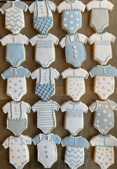 baby ones and onesuits decorated cookies on a table