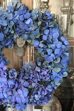 an instagram photo with blue flowers and a clock on the front door is shown