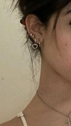 a close up of a person wearing some kind of earring on their left side