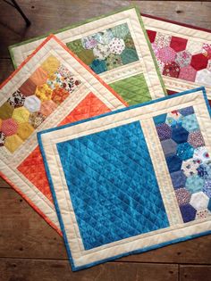 three quilts are laying on top of each other in different colors and patterns,