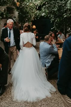 the back of a bride's dress as she walks down the aisle with her father