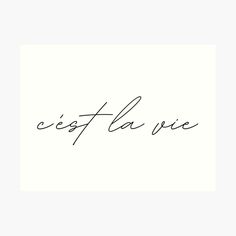 the word cest la vie written in cursive handwriting on a white background