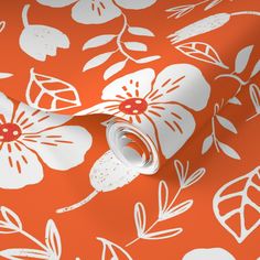 an orange floral wallpaper with white flowers