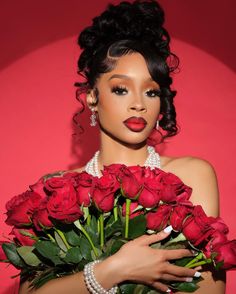 a woman holding a bouquet of red roses