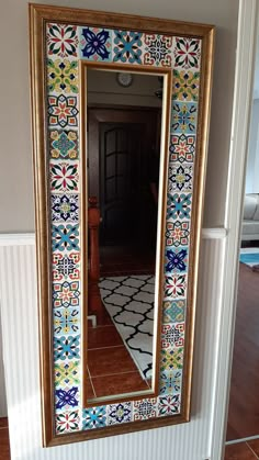 a large mirror sitting on top of a wooden floor