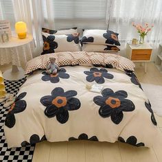 a bed with black and white flowers on it