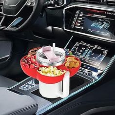 the interior of a car with an automatic cup holder and food tray in front of it