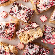 several pieces of peppermint cookie bars with chocolate and sprinkles on top