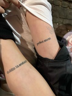 two people with tattoos on their arms and one has the words perfect storm written in cursive writing