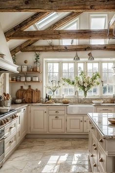 a kitchen filled with lots of white cabinets and counter top space next to a window