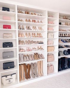 a closet filled with lots of shoes and purses next to a wall mounted shelving unit