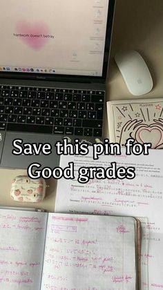 an open laptop computer sitting on top of a desk next to a mouse and notebook