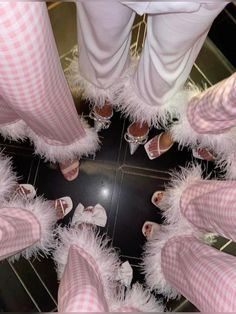 a group of people in pink and white outfits