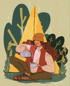 a woman sitting on the ground holding a cup