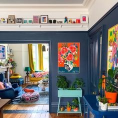 a living room filled with furniture and lots of plants