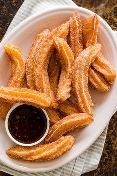 fried onion rings on a plate with dipping sauce