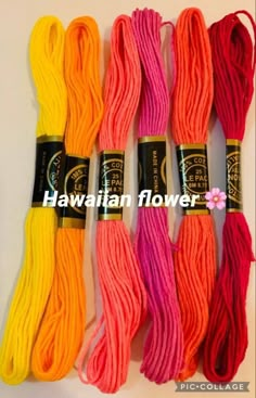 six skeins of colorful yarn with the words hawaiian flower written on each end