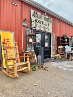 an old fashioned rocking chair sitting in front of a furniture store