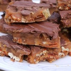 several pieces of chocolate and nuts on a white plate