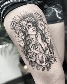 a woman's thigh with flowers and leaves on her leg, in black and white