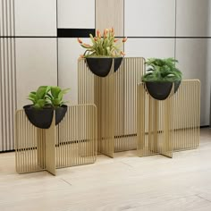 three planters that have plants in them