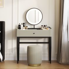 a vanity with a mirror, stool and other items on the table in front of it