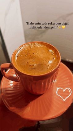 a cup of coffee on top of a saucer with a heart drawn on it