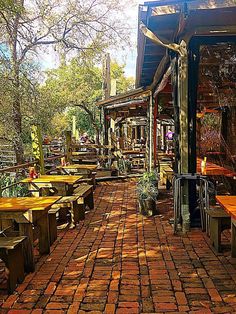 an outdoor seating area with tables and benches