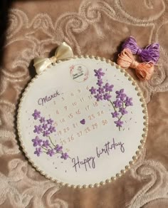 a cross stitch birthday card with flowers on it