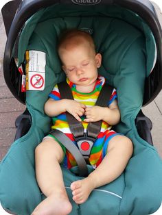 a baby is sleeping in a car seat