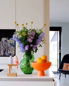 a vase filled with flowers sitting on top of a counter