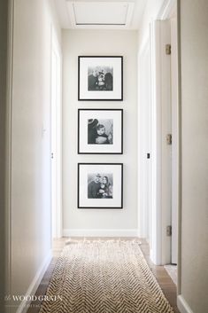 the hallway is clean and ready to be used as a place for family photos on the wall