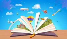 an open book sitting on top of a wooden table next to a hot air balloon