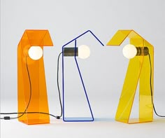 three different colored lamps sitting next to each other