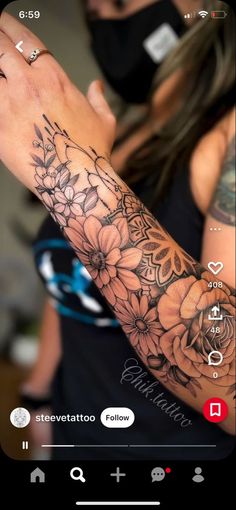 a woman with a tattoo on her arm and wrist is looking at the phone screen