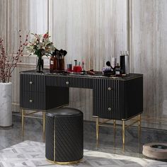 a vanity table with two stools in front of it and flowers on the side