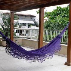 a purple hammock sitting on top of a patio