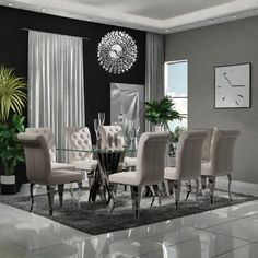 a dining room table with chairs and a clock on the wall