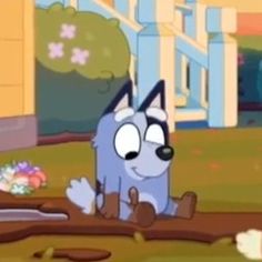 a cartoon dog sitting on the ground in front of a building with flowers around it