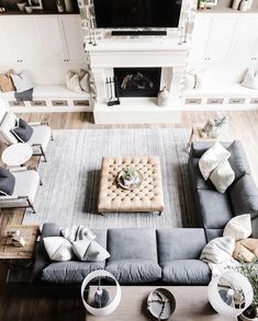 an overhead view of a living room with couches, chairs and a fire place