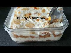 a close up of food in a plastic container with a spoon on the side and words crispy & yummy above it