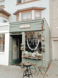 an old fashion store with chairs and tables outside