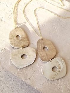 three pendants are hanging on a white surface