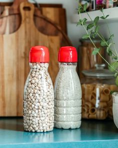 two salt and pepper shakers sitting on top of a blue counter