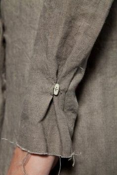 a close up of a person's pants with buttons on them